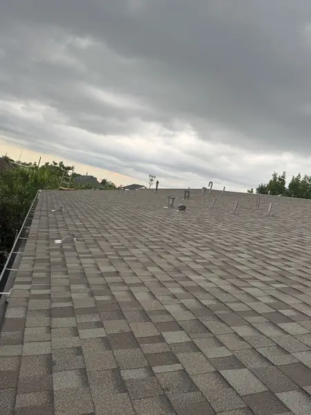 Replacement shingles and resealed penetrations on the rear slope
