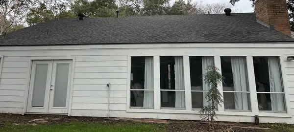 Rear elevation of a one-story Katy home after roof replacement
