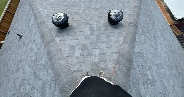 Two turbine vents on the rear slope of a replaced roof in 77064