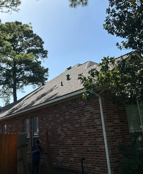 Rear hip slope with new shingles and ridge vent, Cypress 77429