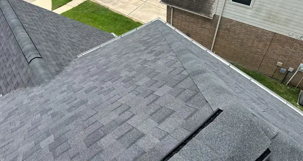 Side slope of a new charcoal laminate roof in northwest Houston
