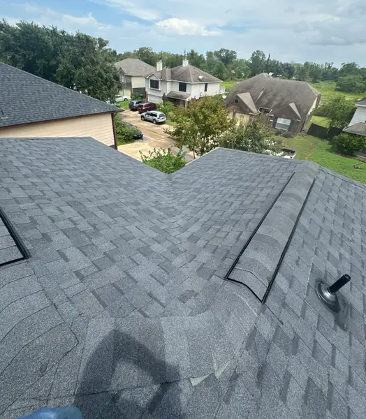 Driftwood laminate roof and brick chimney on a one-story Houston home in 77071