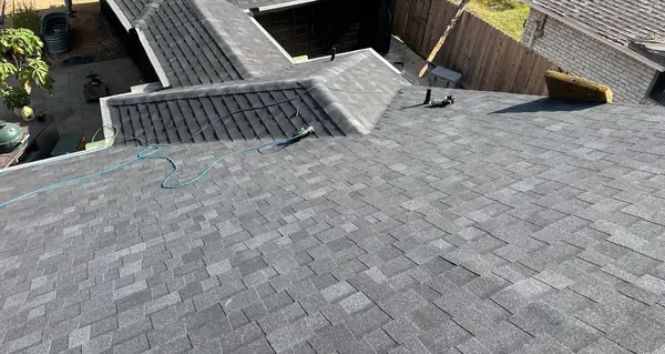 Slate-gray laminate roof and brick chimney on a Memorial-area home in Houston 77079