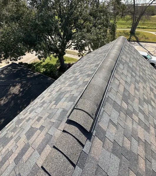 Driftwood laminate roof with ridge vent on a Champions-area Houston home in 77066