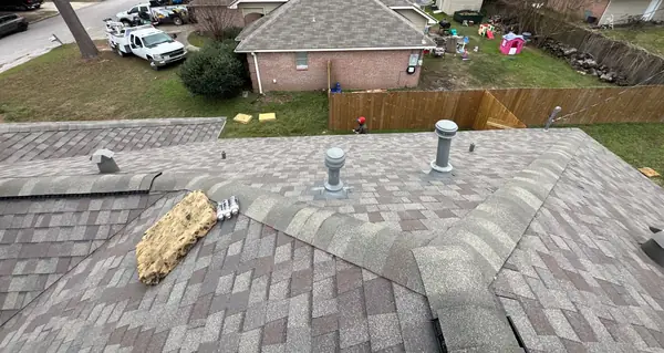 Turbine vents and lead pipe boots on a new Weathered Wood roof in Conroe