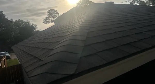 Side slope of a replaced roof with new gutters in Houston
