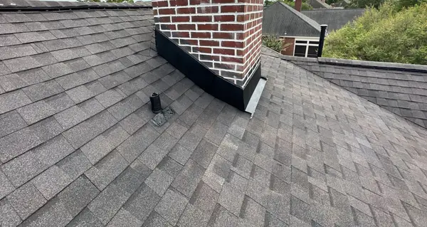 Rebuilt step flashing at the brick chimney