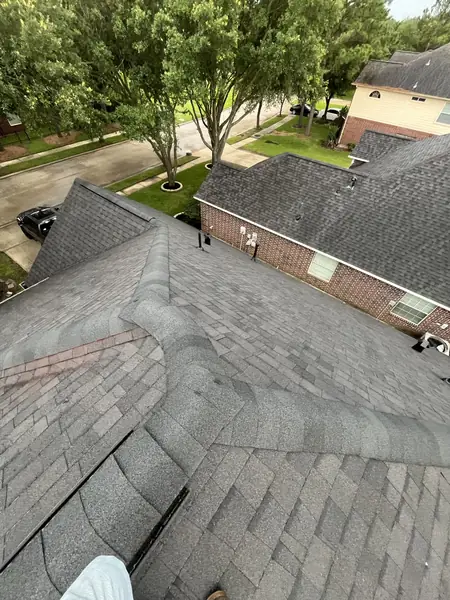 New weathered-gray shingles on the front slope of a Houston home