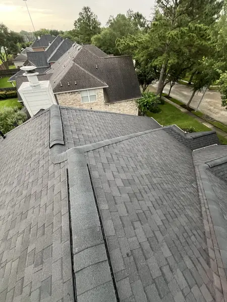 Replaced roof and white chimney chase on a Copperfield home in Houston 77095