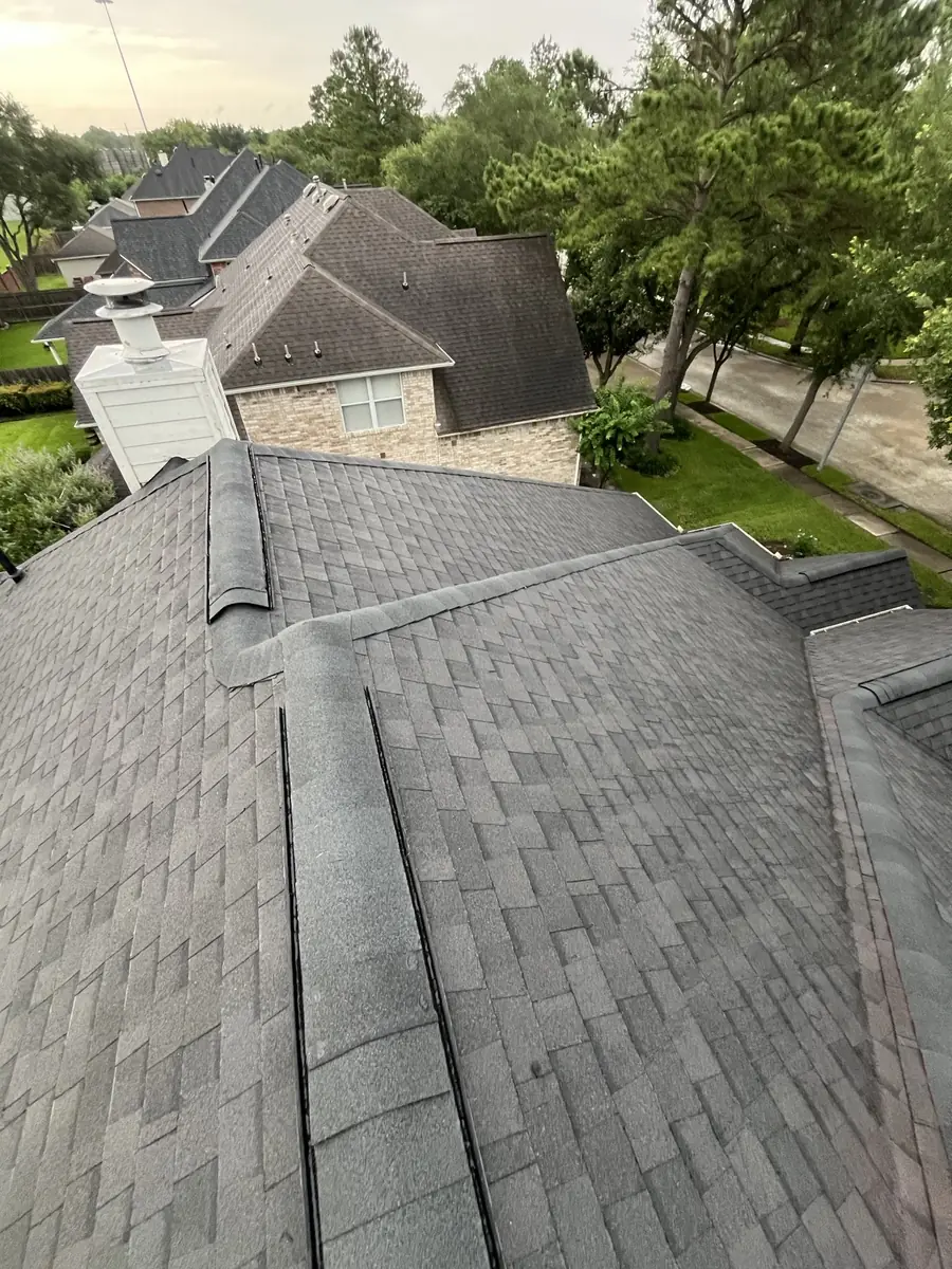Replaced roof and white chimney chase on a Copperfield home in Houston 77095