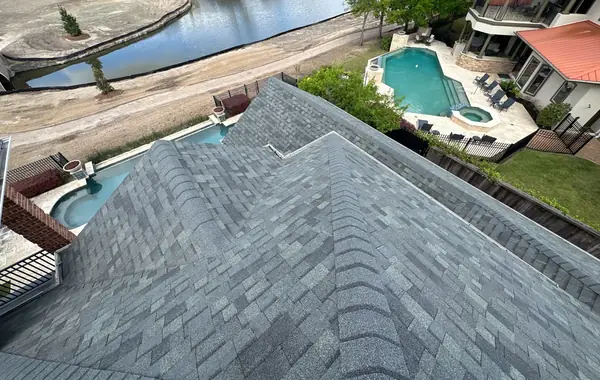 Rear roofline with the lake and dock behind the house