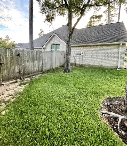 Rear slope and fence line after the replacement, Cypress 77429