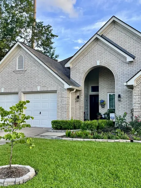 Front elevation showing the completed roof over the entry and garage