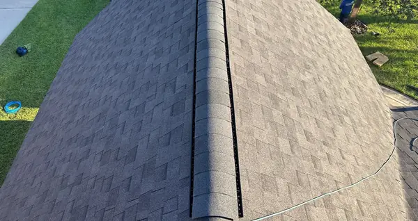 Looking down the peak of a 10/12 roof after replacement, Spring 77373