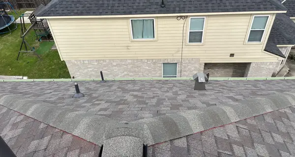 Rear of a two-story Spring home with the new roof, 77373