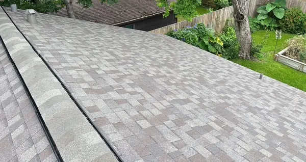 New driftwood laminate roof and ridge cap on a Spring Branch home in Houston 77055