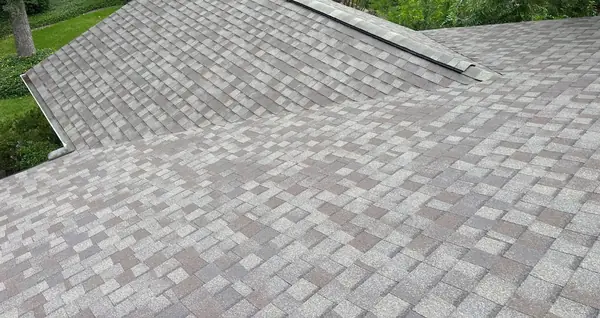 Rear slope of a new shingle roof over a Houston backyard