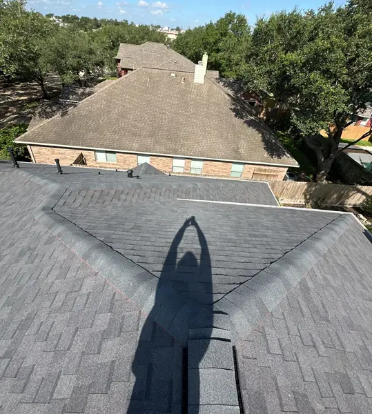 Rear hip ridge of a December 2024 roof replacement in west Houston