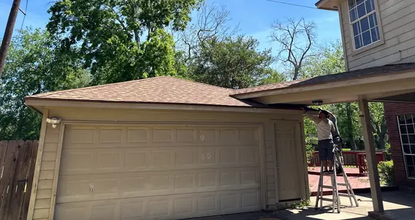 New garage door and roof on a Sugar Land, TX home