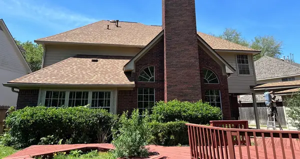 Back of a Sugar Land home with a new Resawn Shake roof