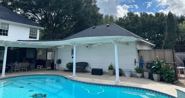 Covered patio and pool with a new roof above in Richmond