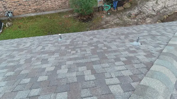 Front slope of a new roof under pine trees in Kingwood
