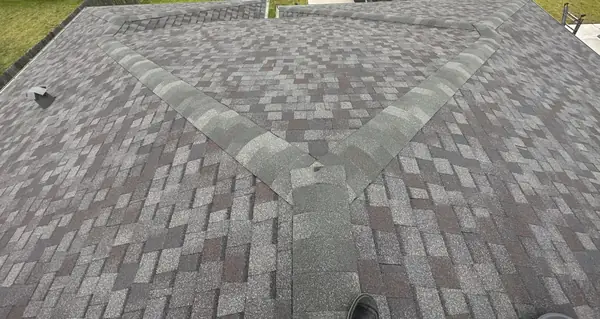 Gray laminate roof with capped hips on a Rosharon home in 77583