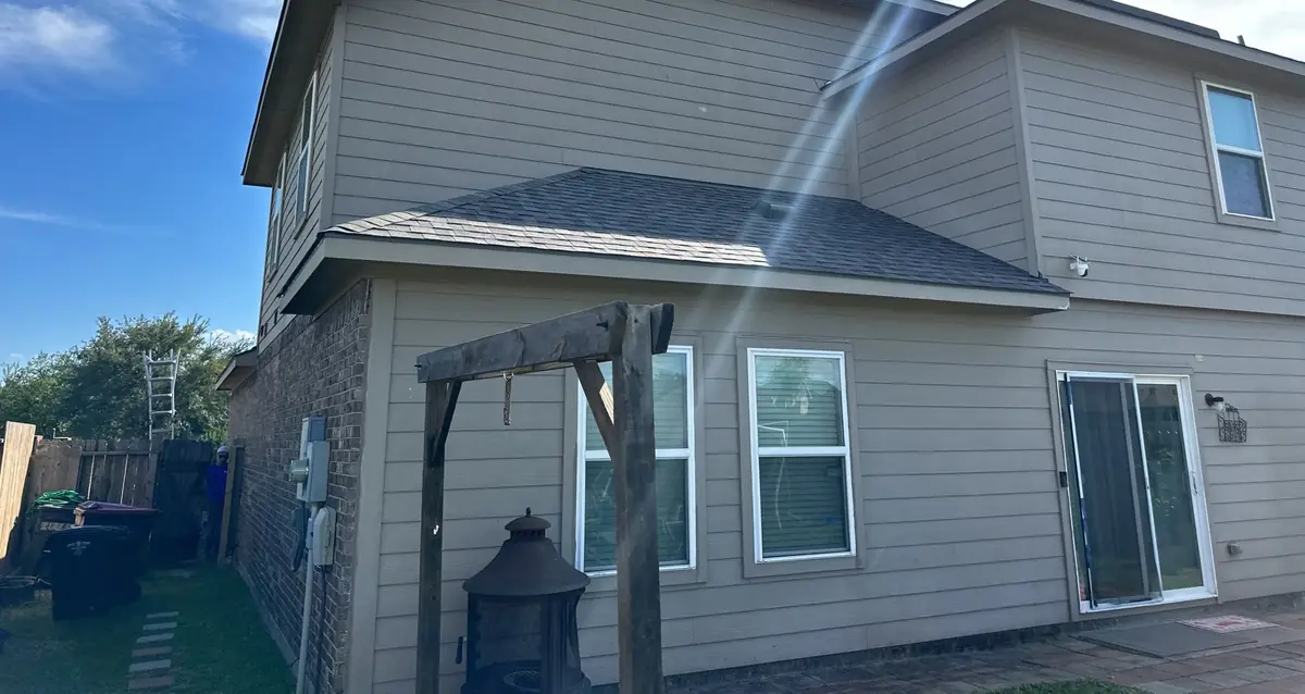 Back patio of a two-story Cypress home with the new gray roof
