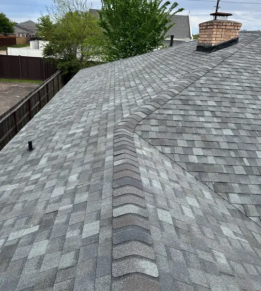 Finished silver-gray laminate roof with brick chimney on a Houston home in 77084