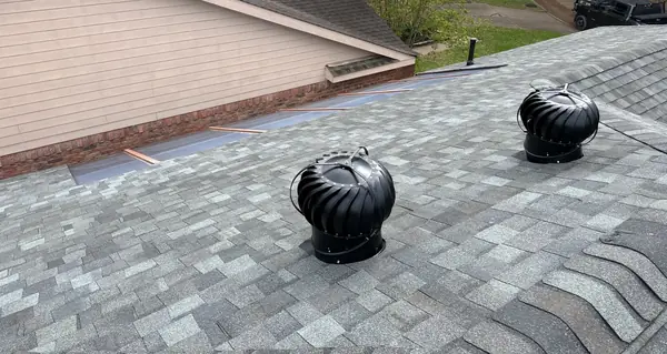 Two new turbine vents on the ridge of a Houston roof