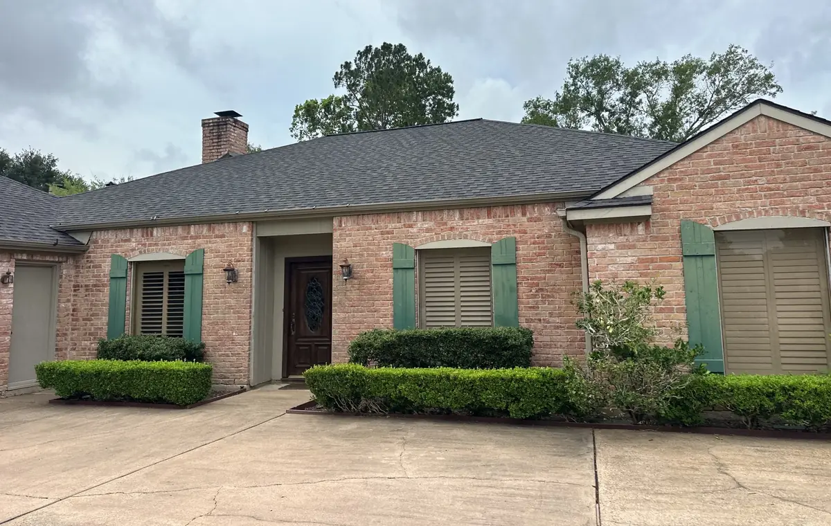 One-story brick Missouri City home with a new driftwood laminate roof in 77459