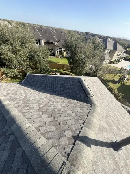 Gray laminate roof with capped hips on a Greatwood home in Sugar Land 77479