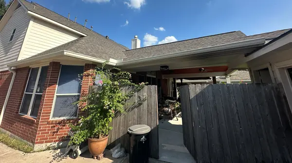 Side gable and new roof over a fenced patio in Houston