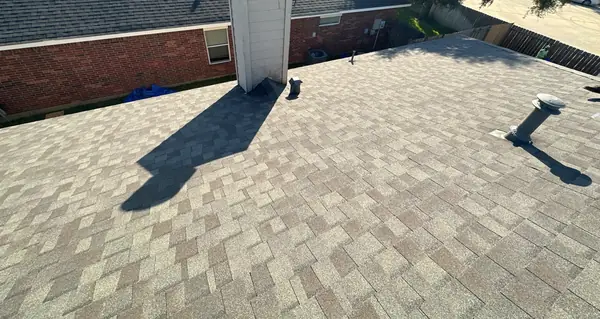 Chimney and front slope of a new Weathered Wood roof in Katy