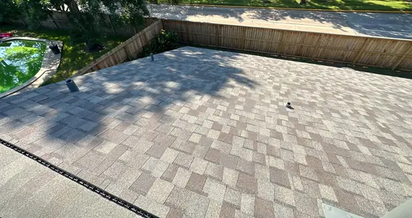 Rear slope and fence line of a replaced roof in northwest Houston
