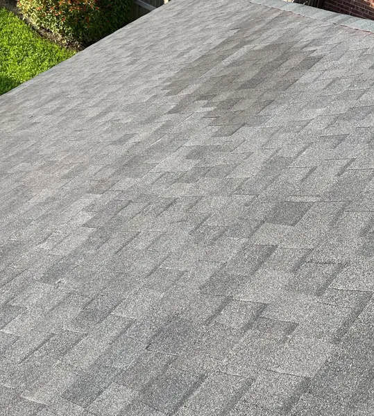 Close view of matched charcoal shingles on a replaced Houston roof