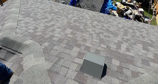 New air hawk vents and ridge caps on a Weathered Wood roof in Cypress