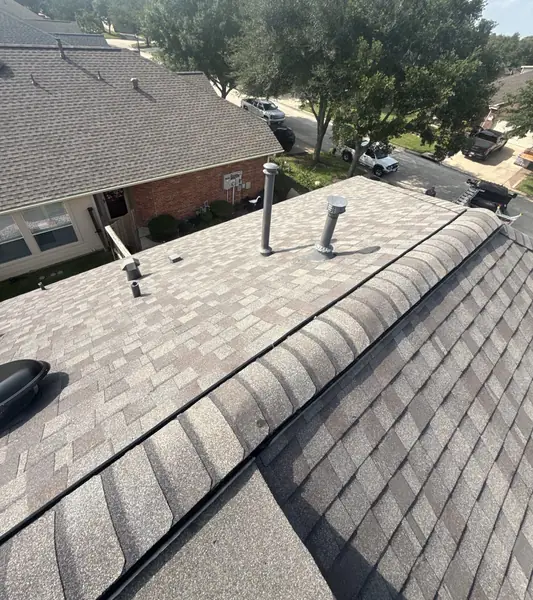 Driftwood laminate roof and brick chimney on a Pearland home in 77581