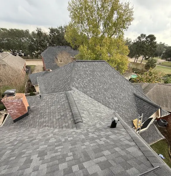 Brick chimney re-flashed on a new laminate roof in northwest Houston