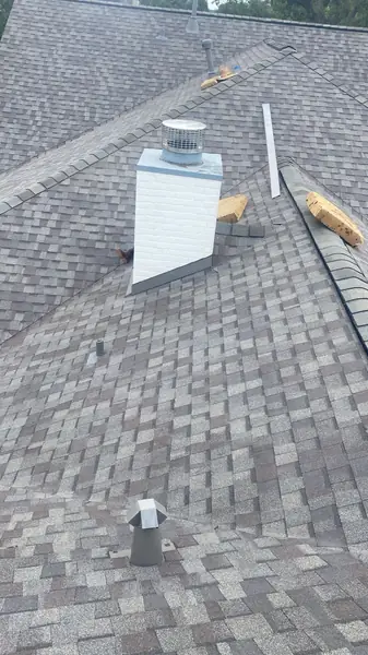 Weatherwood laminate roof and brick chimney on a one-story home in Houston 77019