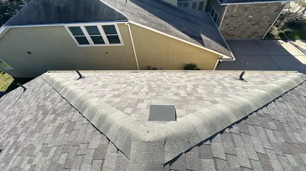 Covered patio roof tied into the main hip of a Katy home