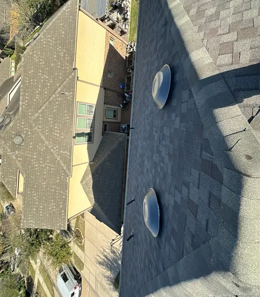 Top-down view of a new dome vent and the roof edge