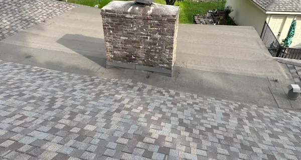 Stone chimney and flat roof section after the replacement