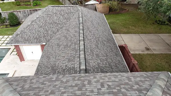 Weathered-gray laminate roof on a two-story Houston home in 77094