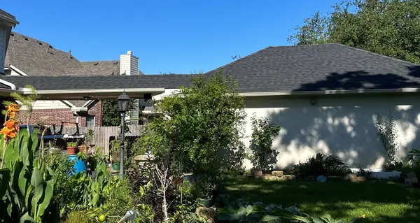 Side elevation of a replaced roof over a one-story wing in Houston