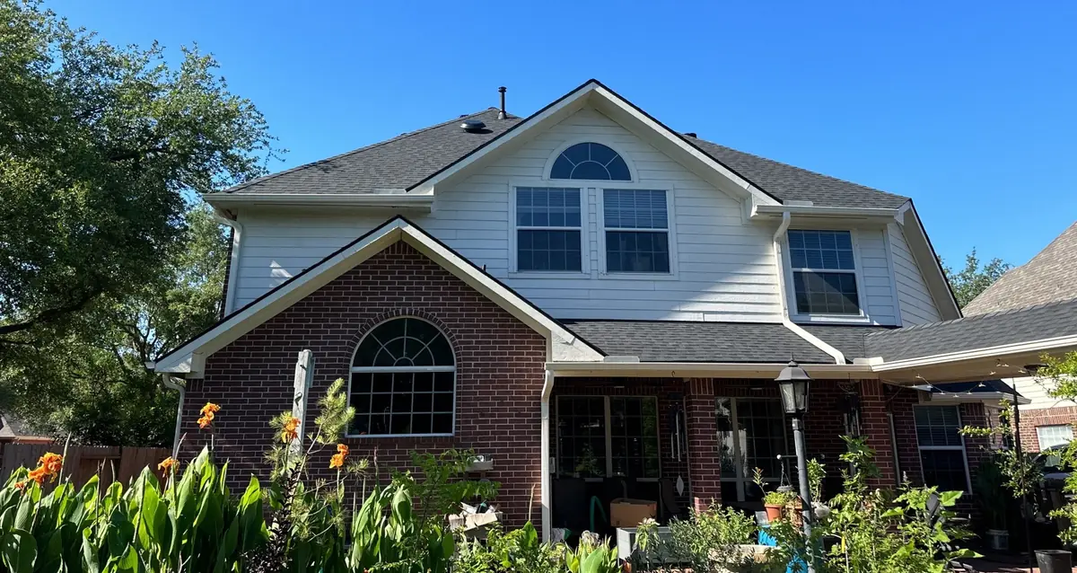 Two-story brick and siding Houston home with a new CertainTeed roof in 77064