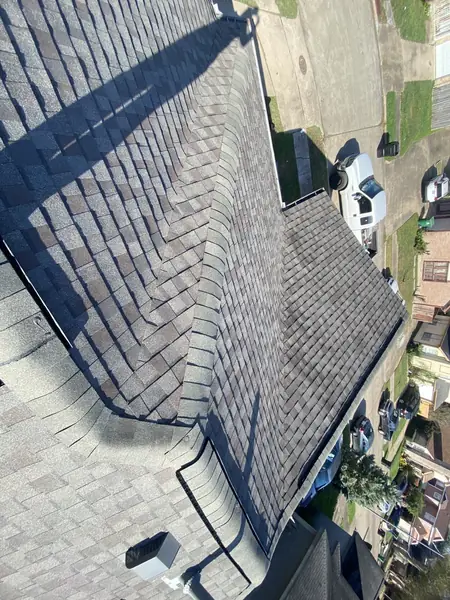 Low-slope roof with fresh shingles after a two-layer tear-off in Houston