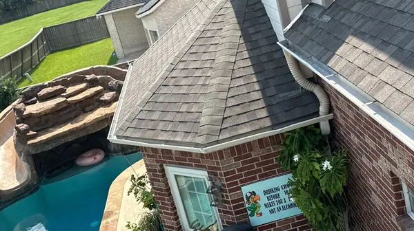 Driftwood laminate roof and chimney on a two-story Pearland home in 77581