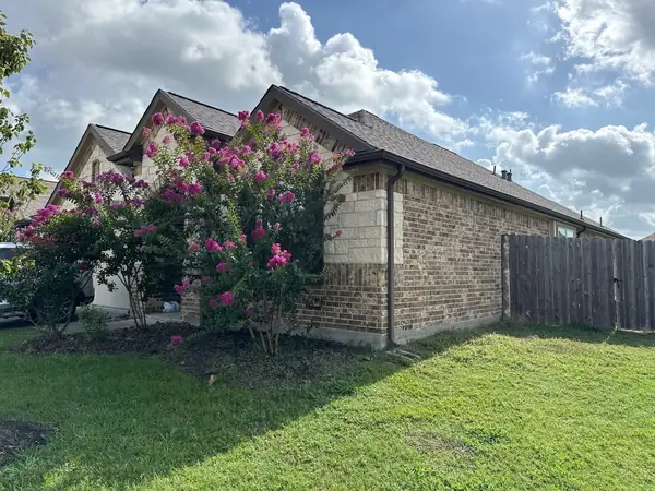 Side elevation of the brick home with the completed roof