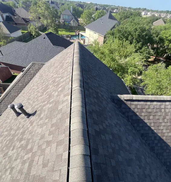 Driftwood laminate roof with ridge vent on a two-story Pearland home in 77581